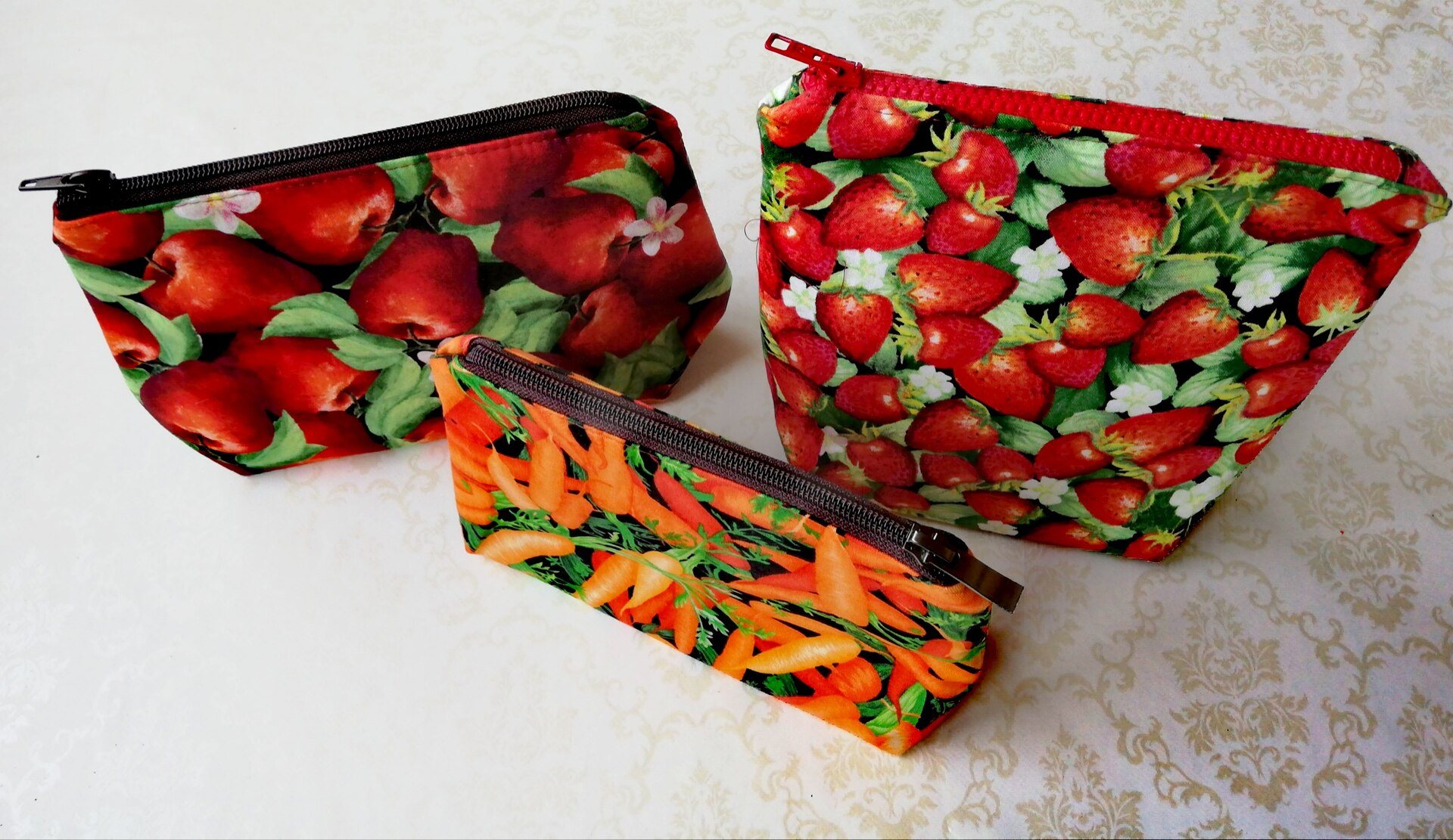 Three fabric pouches with fruit and vegetable prints
